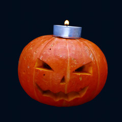 pumpkin and candles on a dark background