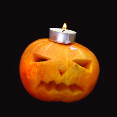 pumpkin and candles on a dark background