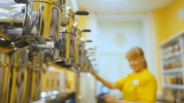 Woman in shop with tow of beer taps
