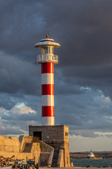 Lighthouse in the port just before the storm