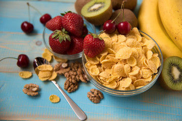 Tasty cornflakes with walnut in glass bowl