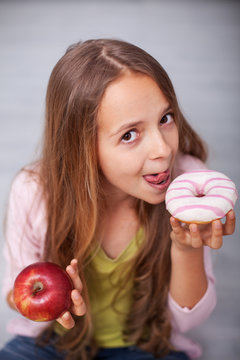 Young teenager girl tempted by the sugary food