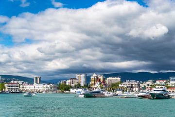 Obraz premium beautiful view of the sea Bay with yachts near the shore and thick clouds in the sky.