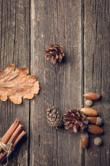Autumn leaves on wooden background. yellow autumn leaves and acorns on the blackboard.