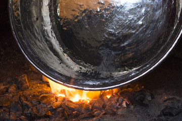 Elderly man in his workshop plates the copper bowl with tin in adana kazancilar bazaar - obrazy, fototapety, plakaty