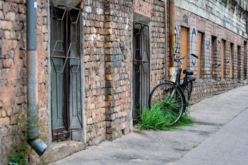 At the old brick building gutters with a lock connected the black bike.