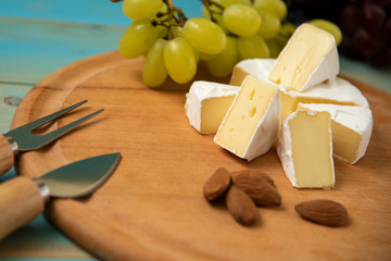 slices of cheese camembert with raspberries and nuts