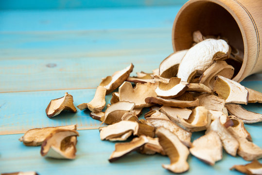 Dried porcini mushrooms on blue wooden background