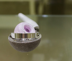 hip replacement implant or hip endoprosthesis exhibited on a glass plate in a hospital. Instrument...