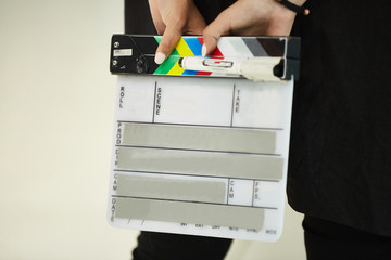 A clapper for shooting movies, A person's hands, is going to write on the flapper