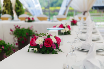 Wedding decoration, table setting, on the table are napkins and flowers