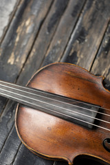 A part of a violin or a viola on a wood background