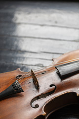 Fototapeta premium A part of a violin or a viola on a wood background