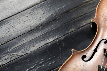 A part of a violin or a viola on a wood background