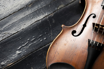 A part of a violin or a viola on a wood background