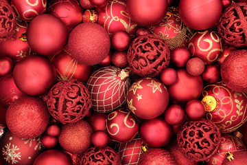 Red bauble christmas decorations forming an abstract background. Traditional christmas greeting...