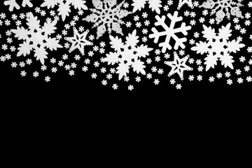 Snowflake christmas and winter abstract background border on black with copy space.