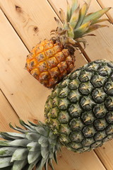 Big and small pineapple on the table