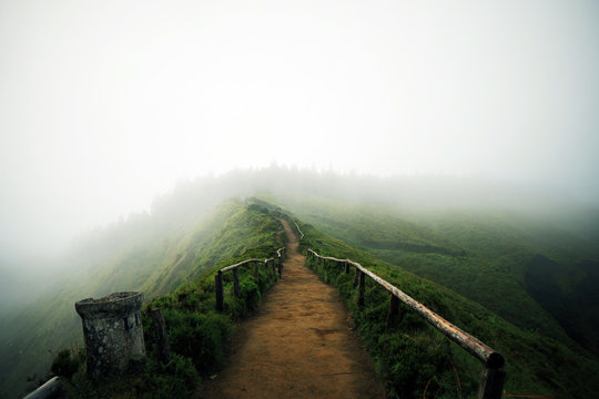 Mountain foggy landscape with hiking trail and view of beautiful lakes Ponta Delgada, Sao Miguel Island, Azores, Portugal. 