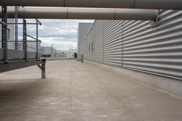 The roof of a modern factory covered with waterproof membranes on a sunny and cloudy day.
