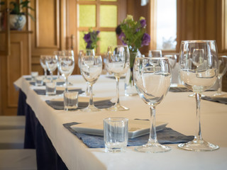 A table served with glasses in the interior of the restaurant.