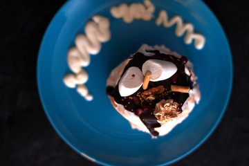 Cake on a blue plate on a black background