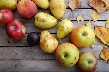 Various colorful fruits on autumn wooden table