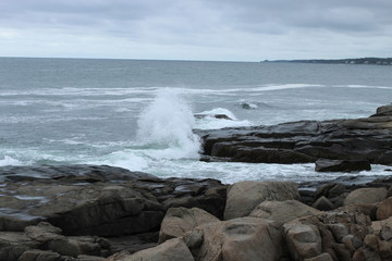 Waves crashing against a breakwater on the Atlantic Ocean in Maine 