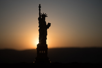 Statue of Liberty on the background of colorful dawn sky