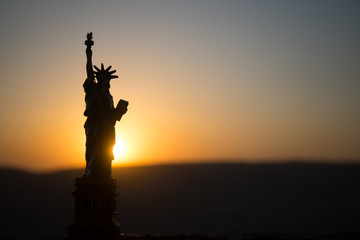 Statue of Liberty on the background of colorful dawn sky