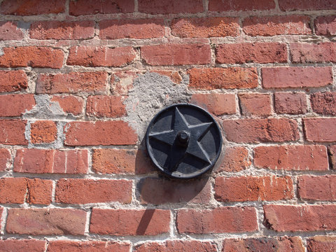 Round Metal Star In A Solid Brick Wall © mcgimpseymike
