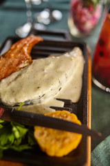 Steak from salmon with sauce and a decanter of a berry drink