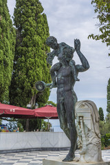 Obraz premium Bronze man with boy on Achilleion palace of princess Sissy in Corfu, Greece