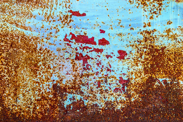 Closeup of rusted metal surface with peeling paint.