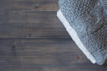 Natural wooden gray background with knitting clothes