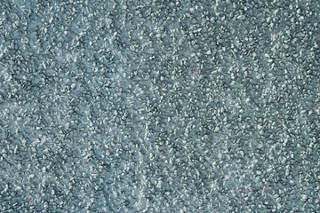 The texture of the plastered wall with a fine gravel of gray-green color...