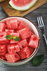 Dessert of sliced ​​slices of watermelon with mint on wooden table, top view