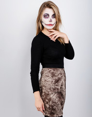 girl in a black sweater on a white background with Halloween makeup
