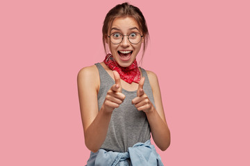 I choose you. Beautiful European woman makes gun gesture, points directly at camera, has appealing...