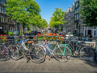 Fototapeta na wymiar Beautiful view of Amsterdam canals with bridge and bikes. Amsterdam, Netherlands