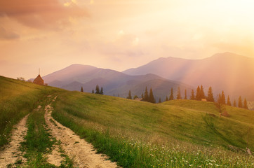Fototapeta premium Summer landscape with mountains, fir forest and the road in hipster vintage retro style