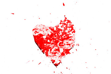Creative photo of a red human heart symbol, broken into small pieces of glass isolated on a white background. Allegory of unhappy love is a broken heart.
