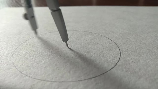 compasses draw a circle on a piece of paper