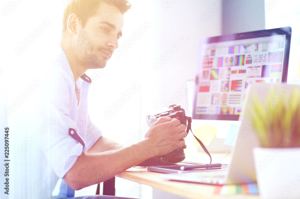 Aufkleber portrait of young designer sitting at graphic studio in front of laptop and computer while working o