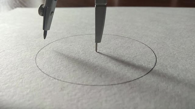 compasses draw a circle on a piece of paper