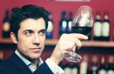 Man tasting red wine