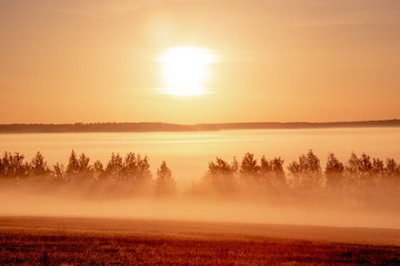 Fototapeta na wymiar Landscape sunrise at summer. Foggy morning on meadow. Filtered image: cross processed effect. beautiful misty sunrise landscape.