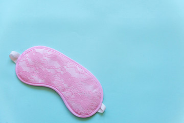 Sleeping eye mask, isolated on blue pastel colourful trendy background. Do not disturb me, let me sleep. Rest, good night, insomnia, relaxation, tired, travel concept