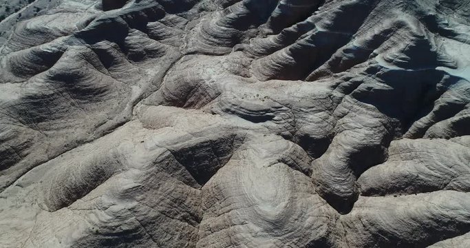 Aerial drone scene top view, geological formations, eroded sandrock mountains, gullies, National Park Talampaya, world natural heritage, La Rioja. Camera moving forwards. Abstract landscape.