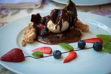 Ice cream with meringue chocolate and berries.